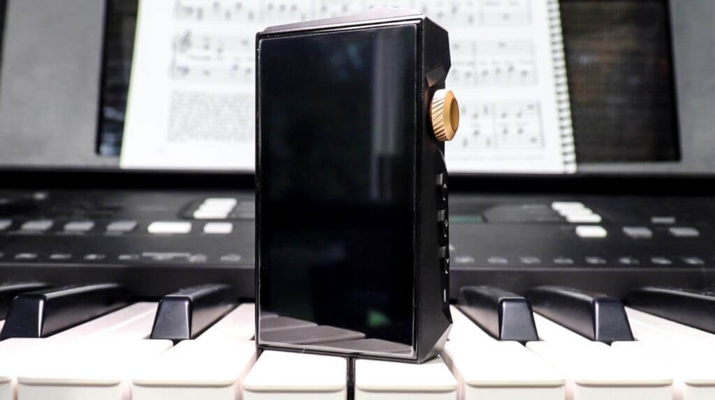 The Hidizs AP80 Pro Max sitting on a piano