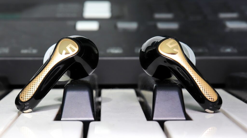 Soundpeats Air5 Pro+ sitting on a piano