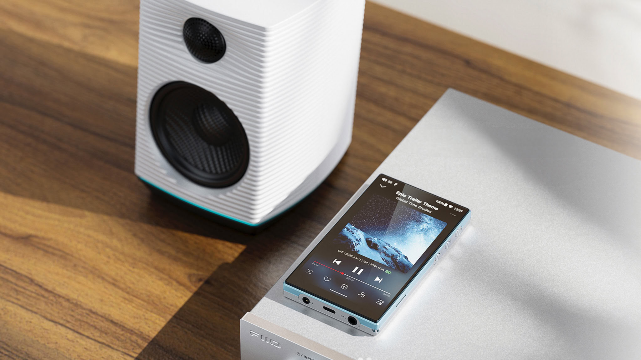 FiiO JM21 digital audio player sitting on top of an audio receiver in sunlight